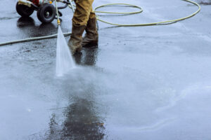 Using pressurized water to clean street, wet washing roadway